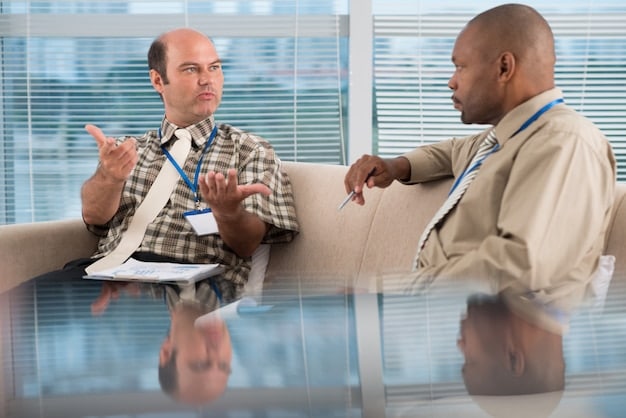 A mediator facilitating a discussion between two employees in a conference room. The mediator is calm and composed, gesturing to encourage open communication between the parties. The atmosphere is professional and supportive.