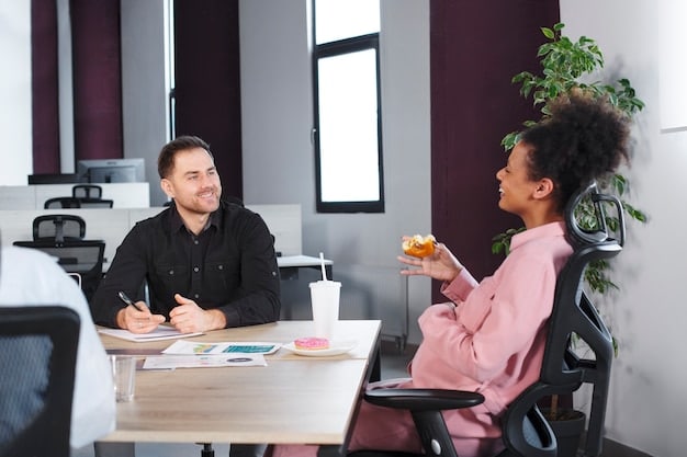 A manager giving positive feedback to an employee during a one-on-one meeting. The atmosphere is supportive and encouraging, highlighting the importance of communication.