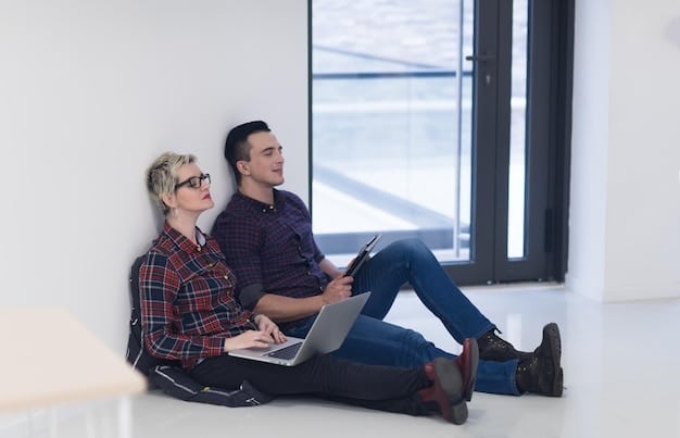 Two co-founders sitting across from each other in a brightly lit, modern office space, engaging in a serious and empathetic conversation. One is leaning forward, listening intently, while the other is speaking with a thoughtful expression. A plant sits on the table between them, symbolizing growth and a nurturing environment.