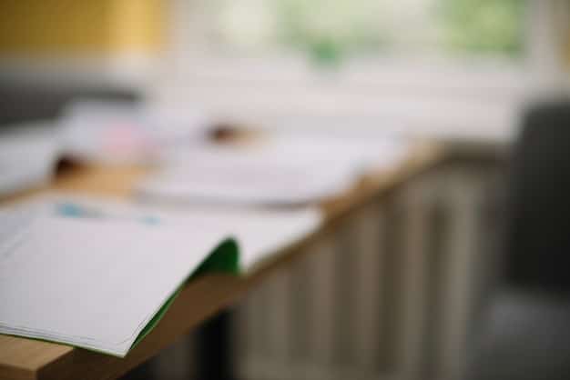 A blurred background of a meeting room with a focus on a document labeled 