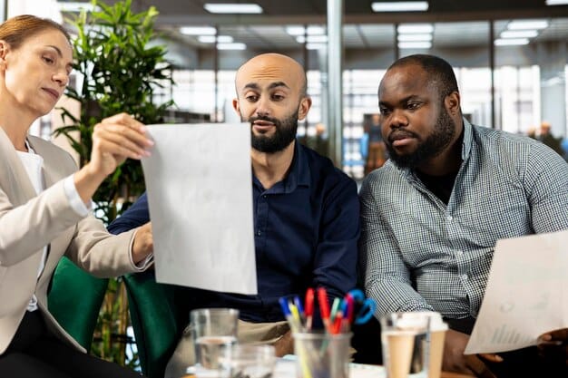 A diverse group of startup employees with concerned expressions, looking at a board with layoff notices in a modern, open-plan office.