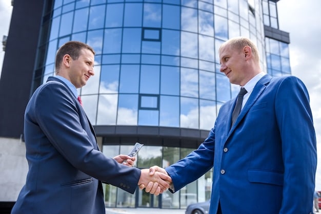 Two founders shaking hands with an investor, with a blurred background of a thriving startup office, emphasizing trust and strategic collaboration.