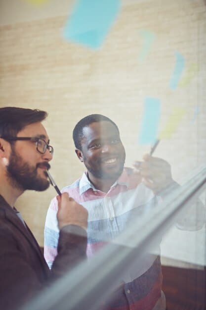 A diverse group of startup employees brainstorming around a whiteboard, with charts and data visualizations illustrating financial projections and R&D budgets.