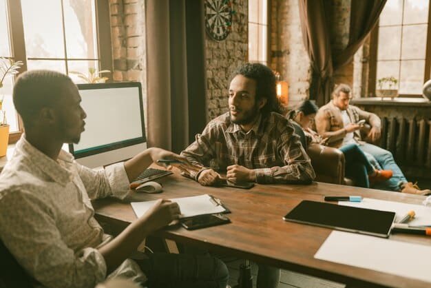 A diverse team of startup founders sitting around a table, engaged in a passionate discussion, representing collaborative decision-making and potential team dynamics.