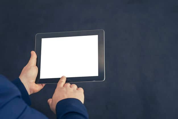 A close-up of a hand holding a tablet displaying a professional pitch deck presentation, with blurred figures in the background suggesting an investor meeting, showcasing the importance of a compelling presentation.