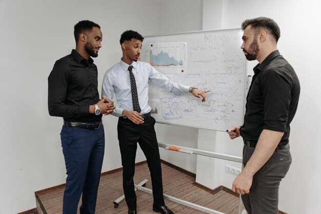 A diverse group of startup founders and investors collaboratively discussing valuation models on a whiteboard, with graphs and figures depicting different valuation methods.