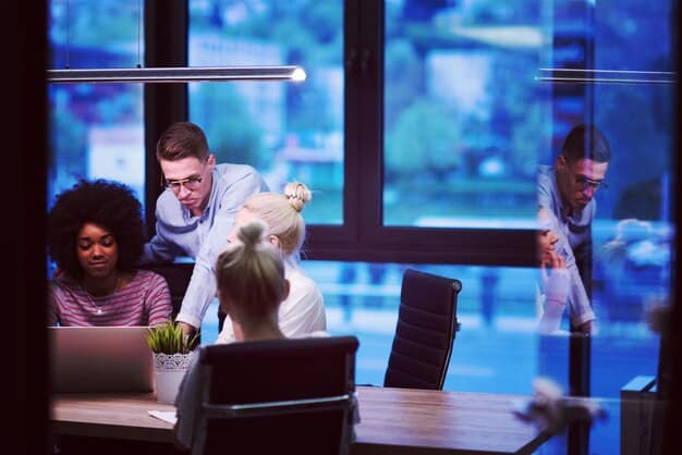 A diverse team of developers collaborating around a glowing holographic projection of code, symbolizing agile development and open-source collaboration in a modern office.