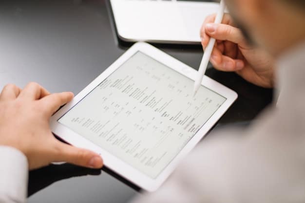 A close-up shot of a pair of hands using a tablet to review financial reports, with several digital charts and graphs displayed on the screen, emphasizing digital financial management.
