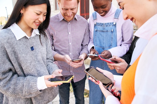 A diverse group of professionals engaging with microlearning modules on their smartphones during short breaks, illustrating the convenience and accessibility of this learning method.