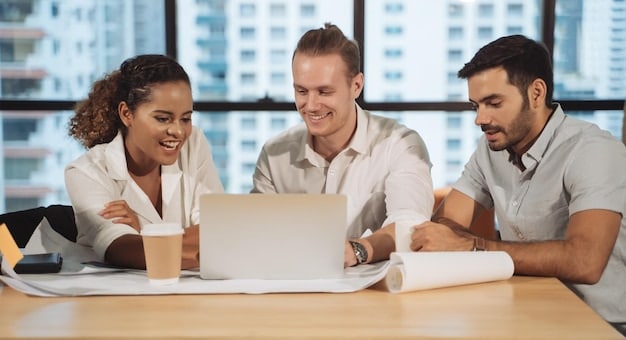 An image of a diverse team working together in an office, collaborating on a laptop to review a grant application. Focus is on the teamwork and attention to detail.